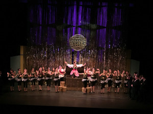World Wide Wicket Treasure Girl Hedy LaRue & the Treasure Hunt Girls emerge from a giant Treasure Chest mid-stage during in "How To Succeed In Business Without Really Trying" at Craterian Theatre, Medford, OR on March 3, 2016
