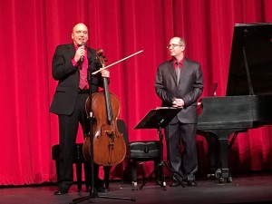 Messrs. Palzewicz and Tutunov explain to audience the story of how they adapted Beethoven's Sonata in F Major, Op. 24, for cello and piano, at Welcoming Spring Concert at North Medford H.S. Auditorium on March 20, 2016