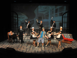 In one of 10 ensemble numbers throughout the show, "Great Big Stuff", Freddy (Eoghan McDowell, center) expounds to Andre (Ernie Rosales, far left) & Lawrence (Erik Connolly, 2nd from left) on his ambitions and what he is seeking, aided by the smartly costumed ensemble (left to right): Jake Hastings, Carrie Ann Eve, Joey Larimer, Shannon Carter, Dylan Spooner & Jasmin Evans. 
